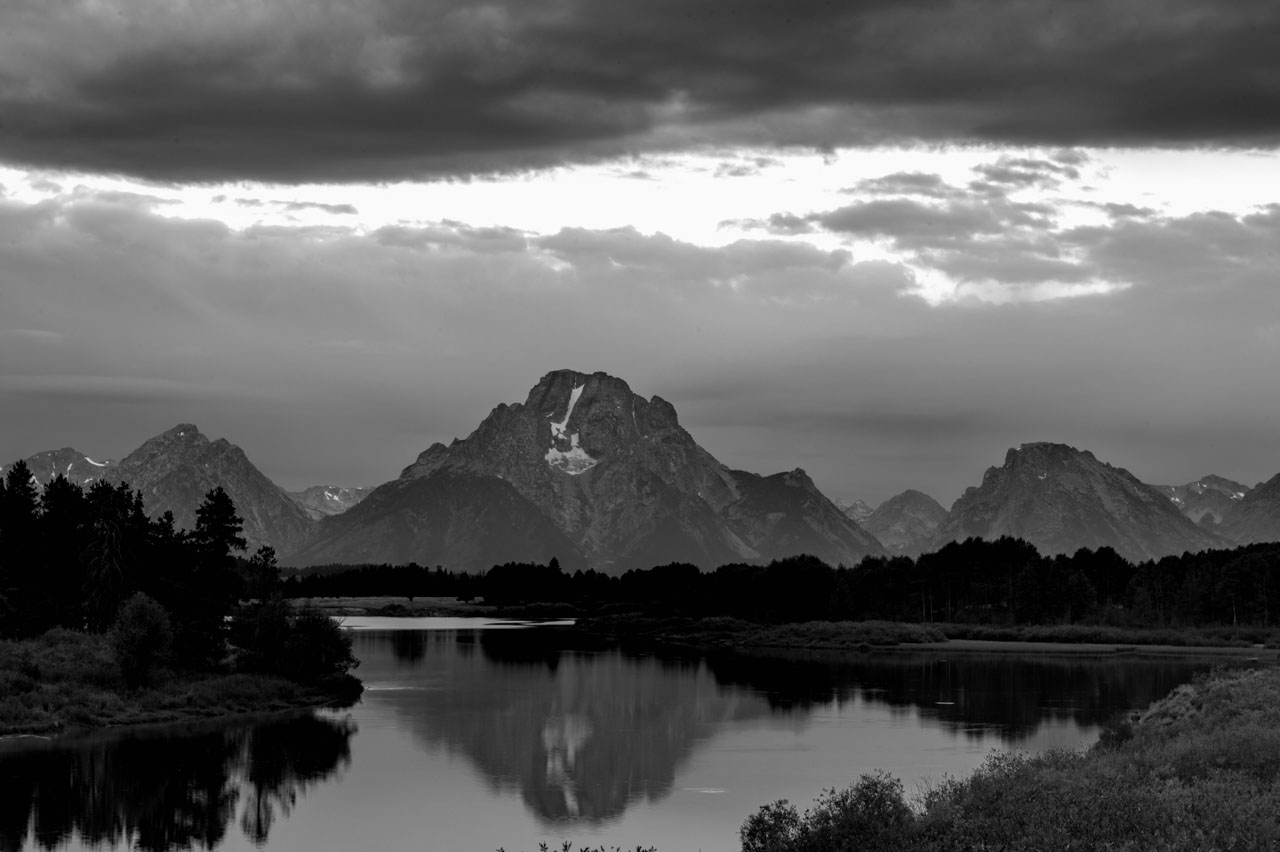 Grand Teton reflecting in a river.
