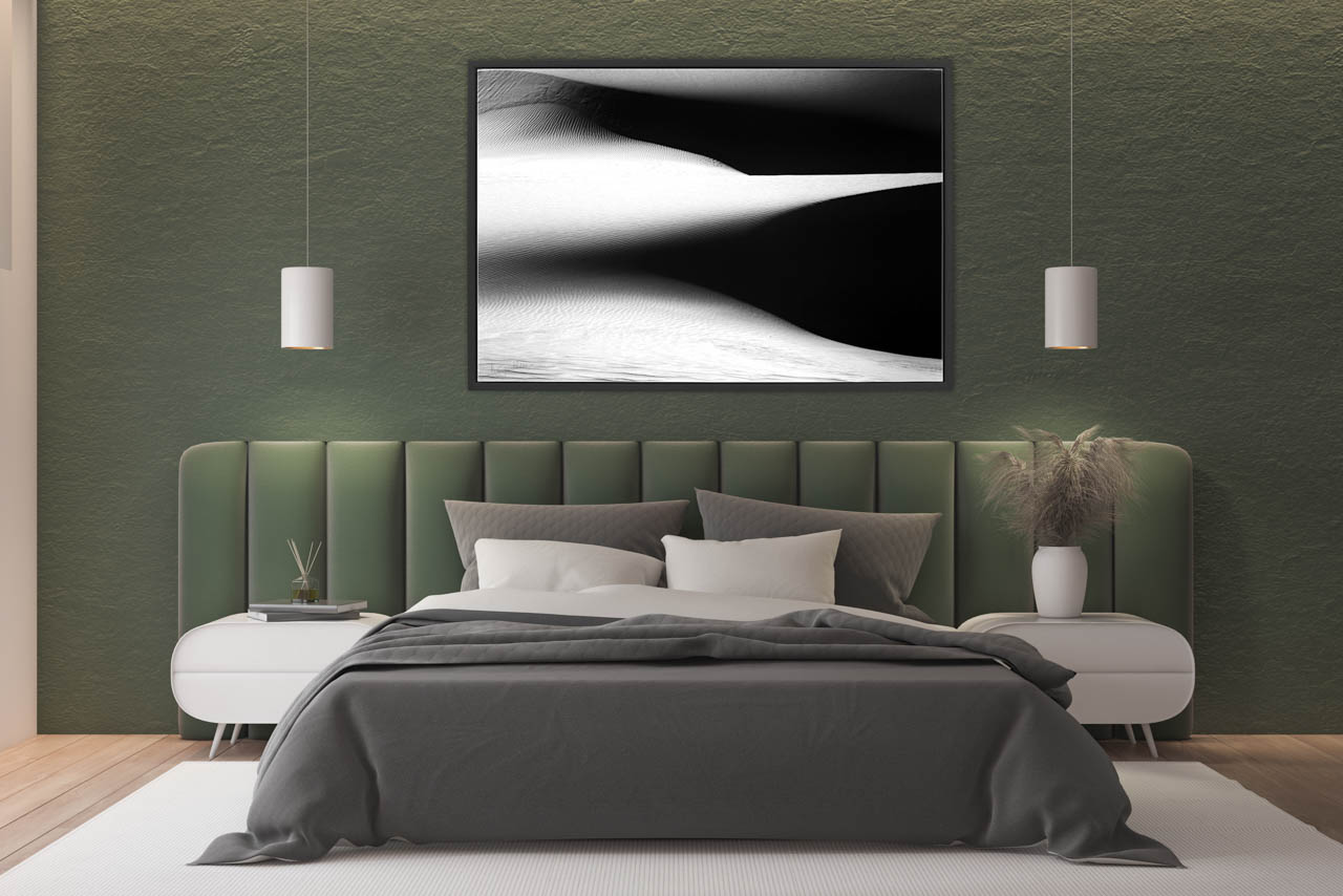 Fine art print in black and white of a landscape of sand dunes exposed in a master bedroom.