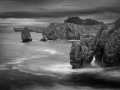 Seascape of Asturias in Spain in black and white.The waves of the Atlantic Oceans break on the rocks of the shore or on the cliffs.