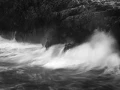 Seascape of Asturias in Spain in black and white.The waves of the Atlantic Oceans break on the rocks of the shore or on the cliffs.
