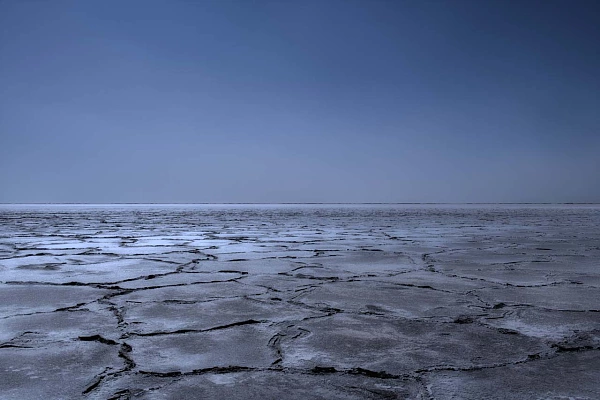 Desertic landscape evoking the drought. Desert of Danakil in Ethiopia. Fine art Photograph in black and white by Amar Guillen, photographer artist.
