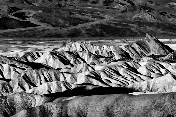 Black and white landscape photograph of Zabriskie Point in Death Valley, United States.